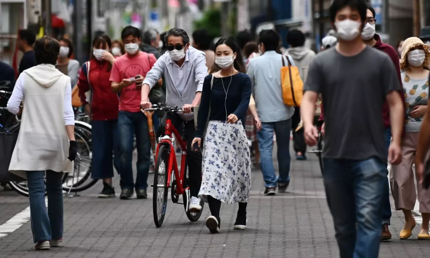 Japans economy shrinks at record rate, slammed by pandemic