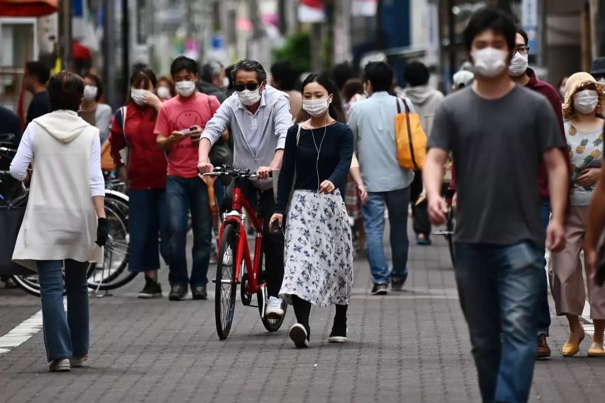 Japans economy shrinks at record rate, slammed by pandemic