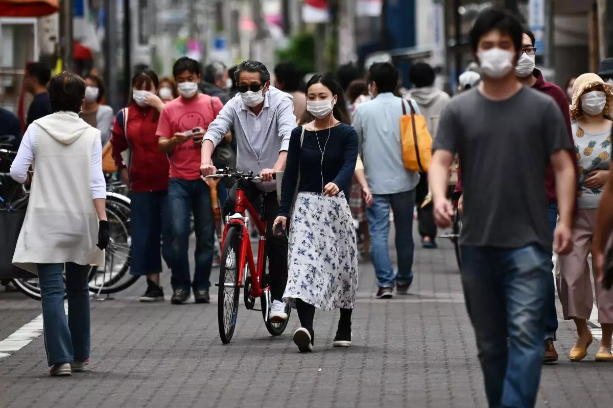 Japans economy shrinks at record rate, slammed by pandemic