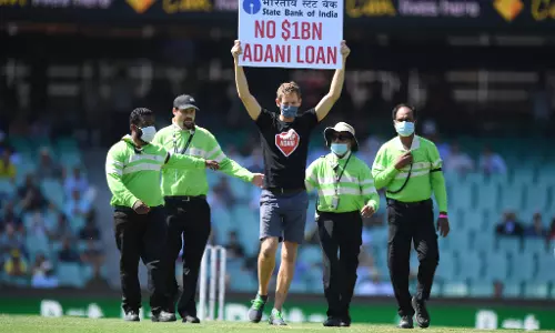 Spectator runs on to field with No $1BN Adani Loan protest sign during first Ind vs Aus ODI