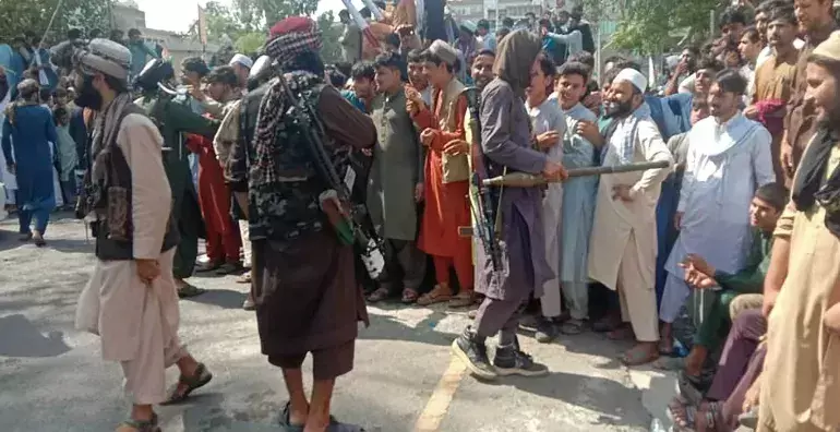 Taliban fighters and local people pictured Taliban fighters and local people pictured