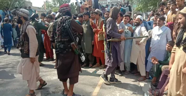 Taliban fighters and local people pictured