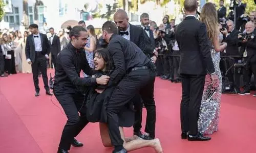 Topless woman storms Cannes red carpet to protest against sexual violence in Ukraine