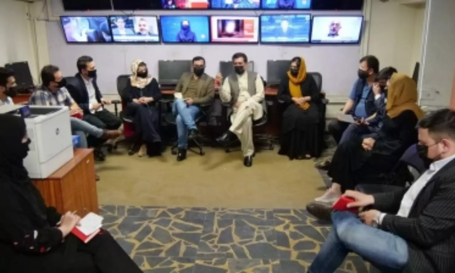 Afghan male TV presenters wear masks in support of their female counterparts
