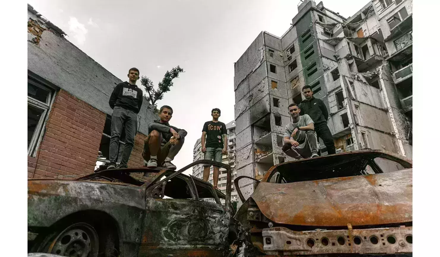 Ukrainian teenagers mark graduation by posing in the ruins of their school