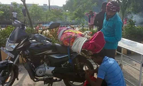 Hospital denies hearse, MP man carries mothers body on bike