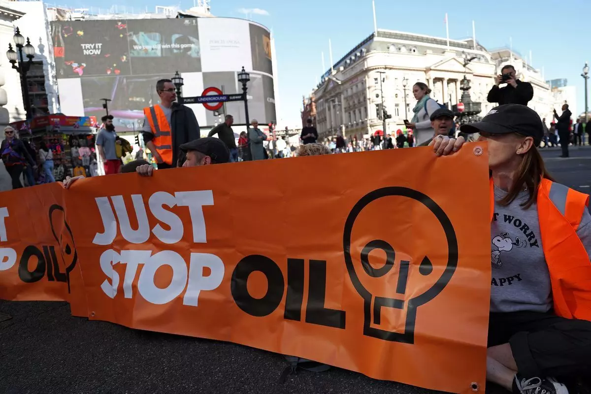 Activists spray paint on Harrods London showroom, Demands end of oil and gas