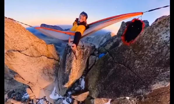 Viral video: man lies in hammock tethered to short mountains