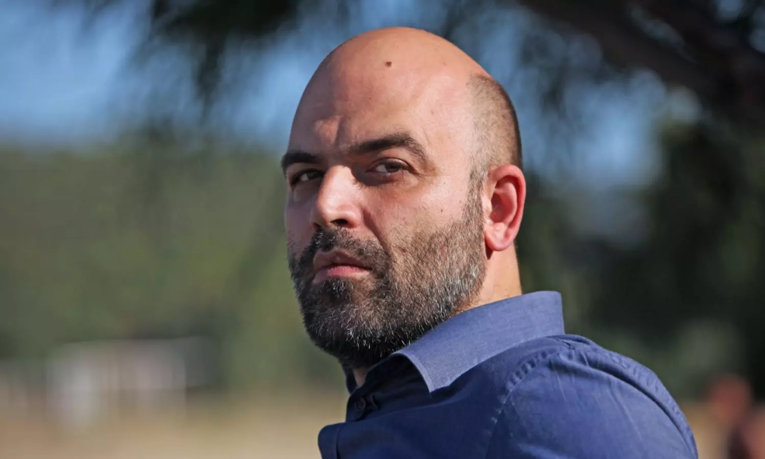 Writer Roberto Saviano faces trial for cussing out Italian PM