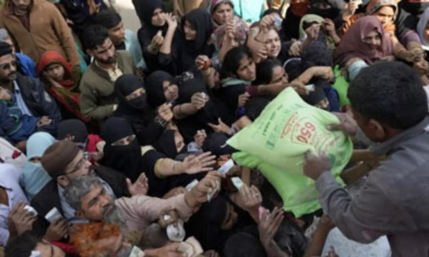 People chase wheat flour truck in Pakistan as hunger deepens