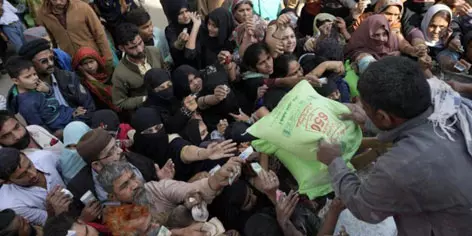 People chase wheat flour truck in Pakistan as hunger deepens