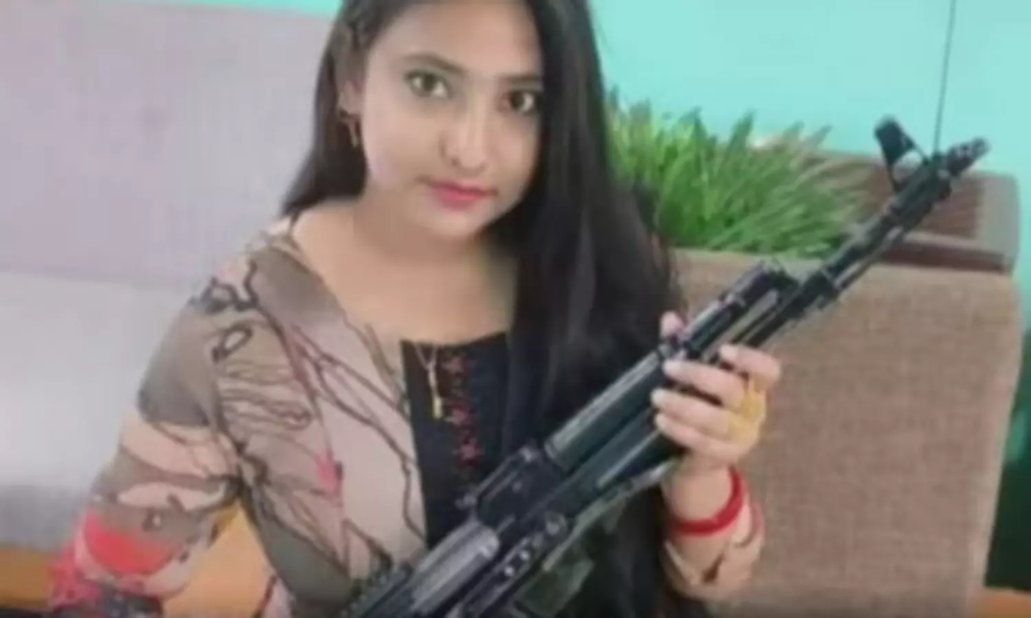Ex-TMC leader’s wife seen holding AK-47 rifle as anniversary gift, leader claims its a toy gun after backlash