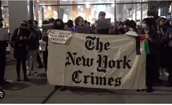 Mock newspaper labelled The New York Crimes’ says ‘We killed our colleagues