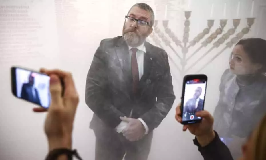 Hanukkah candles put out by far-right Polish MP using fire extinguisher