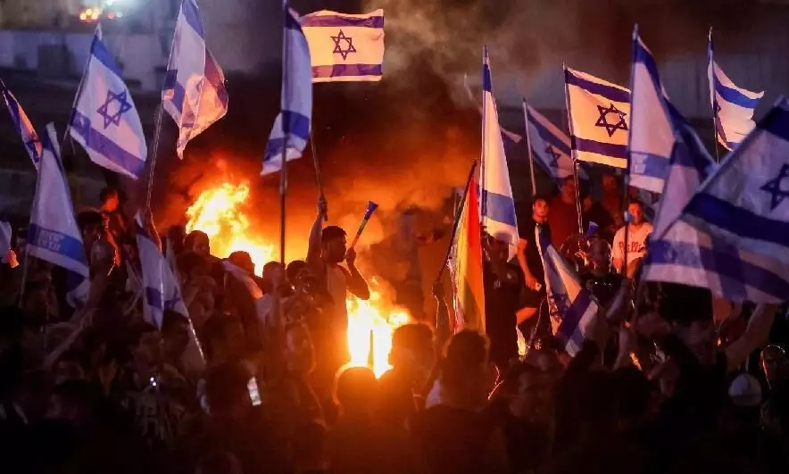 Israeli protesters burn symbolic Passover table outside Netanyahus