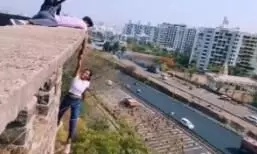 Extreme stunt: Pune woman hangs from a building holding a man’s hand