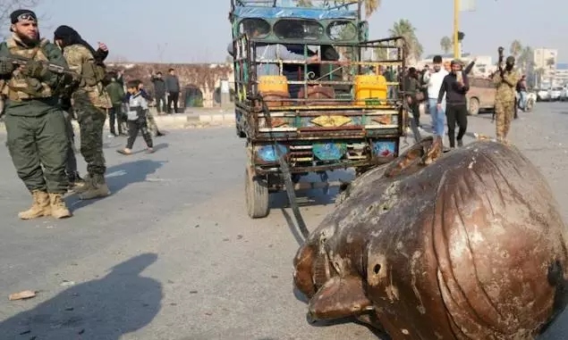 Statues of president’s father dragged through Syrian streets