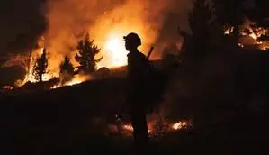 As winds fade, firefighters continue to fight wildfires in California