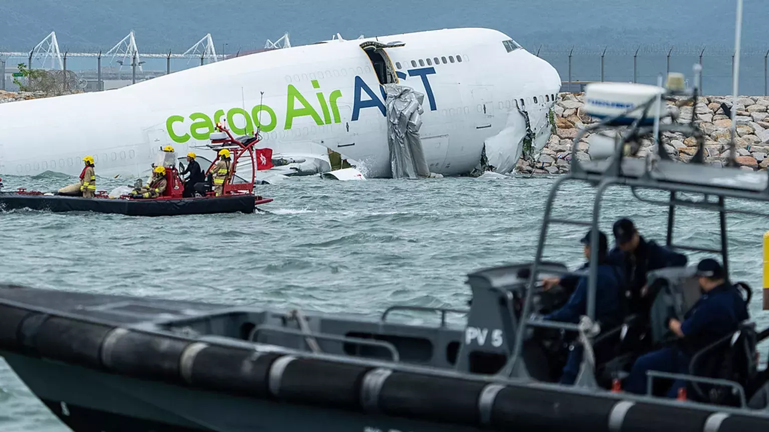 2 killed as cargo plane skids off Hong Kong runway into sea