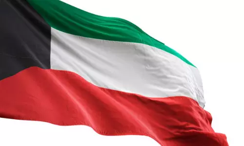 The national flag of Kuwait waving against a clear sky. The national flag of Kuwait waving against a clear sky.