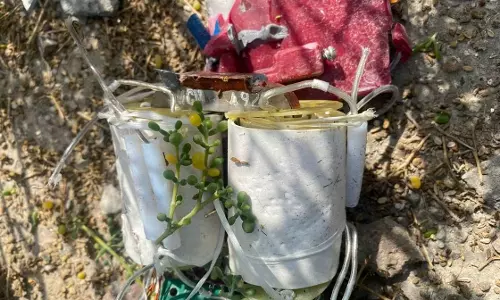 Debris from an intercepted missile lying on the ground in Abu Dhabi, showing damaged metal components and wiring.
