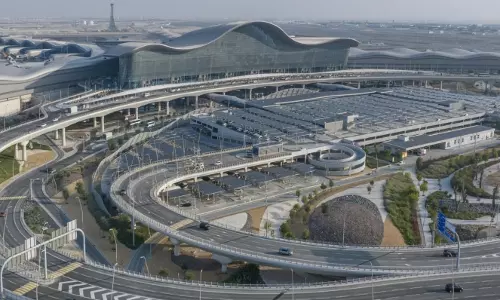 Aerial view of Zayed International Airport terminal building and surrounding highway infrastructure in Abu Dhabi. Aerial view of Zayed International Airport terminal building and surrounding highway infrastructure in Abu Dhabi.