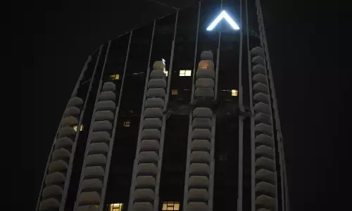 High-rise residential building in Dubai at night following a minor drone-related incident, with authorities confirming the situation was brought under control.