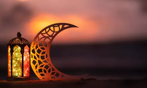 Crescent moon visible in the night sky marking the approach of Eid Al Fitr.
