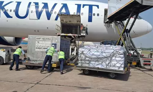 Cargo containers positioned for loading into a Kuwait Airways aircraft during export operations.