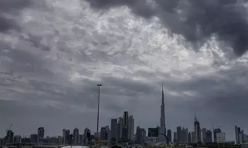 Dark storm clouds gather over Dubai’s skyline with the Burj Khalifa visible in the distance as overcast conditions signal approaching rain. Dark storm clouds gather over Dubai’s skyline with the Burj Khalifa visible in the distance as overcast conditions signal approaching rain.